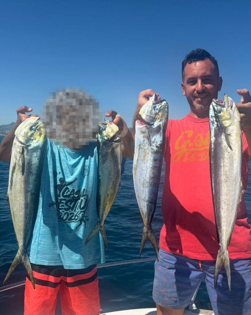 padre e hijo de pesca en el mar, sujetando 4 llampugas pescadas con el señuelo flash de crystal bait
